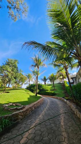 een geplaveide weg in een park met palmbomen bij Pousada do Barão in Lindóia