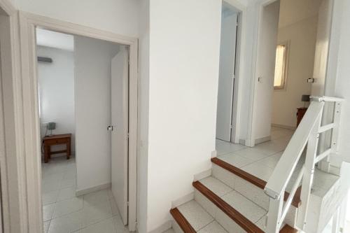 a hallway with white walls and stairs in a house at Apartamentos Las Pérgolas in Son Parc