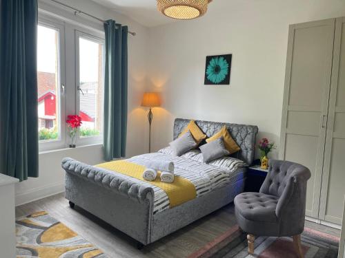 a bedroom with a bed and a chair at Entire Apartment with Self Check-In & Free Parking in Fife