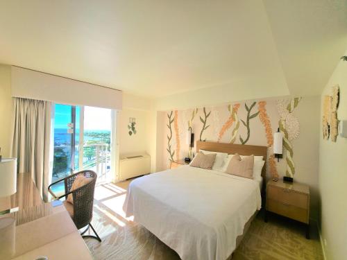 a bedroom with a bed and a large window at Ocean View Room at Ala Moana Hotel- Fees include in Honolulu