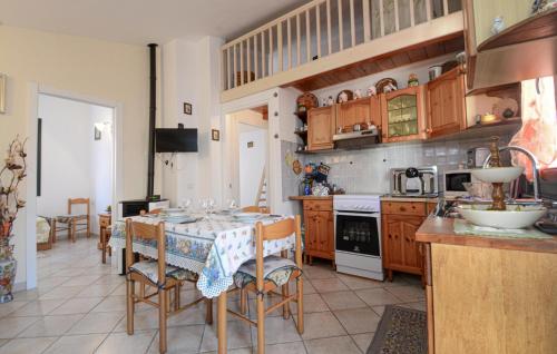 a kitchen with a table and chairs in a kitchen at Lovely Apartment In Sant'antioco With Wifi in SantʼAntìoco