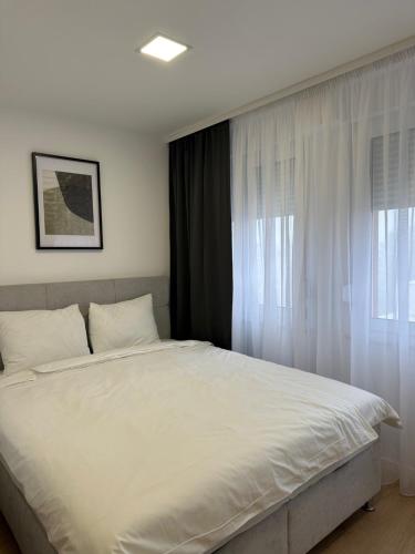 En eller flere senge i et værelse på Apartman Toma