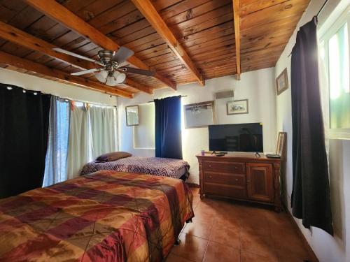 een slaapkamer met een bed en een flatscreen-tv bij Casa Vizcaino in Ensenada