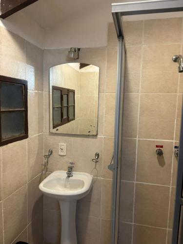 a bathroom with a sink and a mirror at Hostal Distrito in Sucre