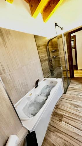 a bathroom with a white bath tub in a room at Casa Stelvio in Turchi