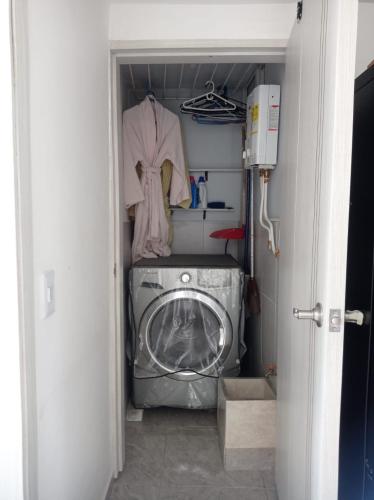 a laundry room with a washer and a washing machine at My Bunker in Cali