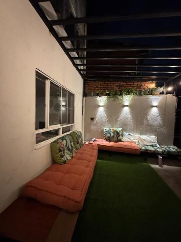 a living room with a couch and a window at My Bunker in Cali