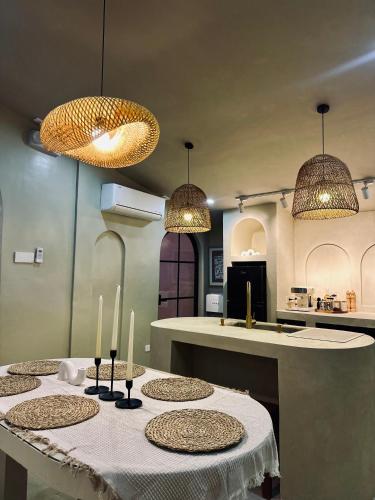 a kitchen with a table with three candles on it at Arko Villa in Katangawan