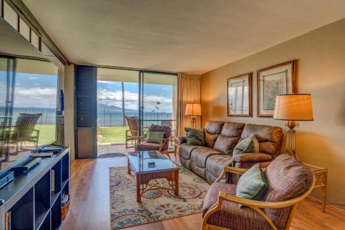 a living room with a couch and a table at Lauloa 102 in Wailuku