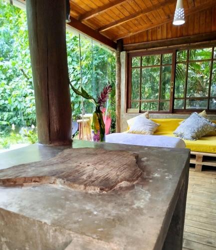 two beds in a room with a large window at Casa Laurus in São Sebastião
