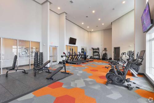 a gym with several treadmills and exercise bikes at Riviere Apartments King Bed Suite & Pool & Gym & Pet Friendly & Near Epic Universe in Orlando