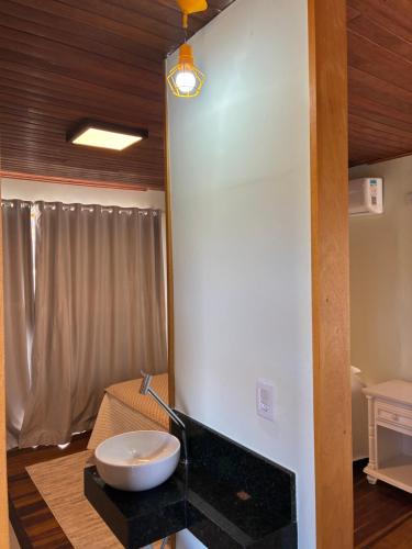 a bathroom with a sink on a counter in a room at Chalé Corumbau - Lapinha da Serra in Santana do Riacho