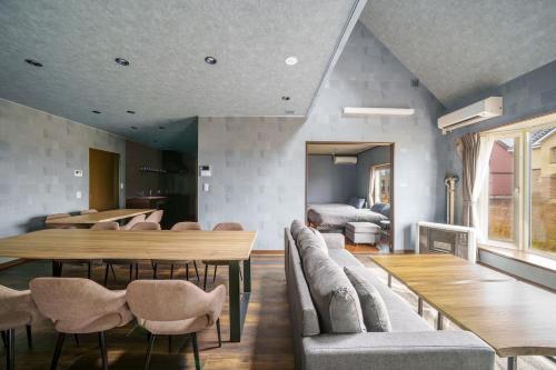 a living room with a table and chairs and a couch at Prostimo in Bibai