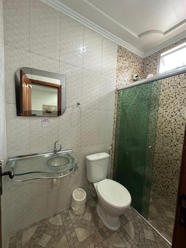 a bathroom with a toilet and a shower and a sink at Hotel Luci in Terra Santa