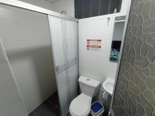 a small bathroom with a toilet and a shower at Proyecto tour yuma tatacoa in Villavieja