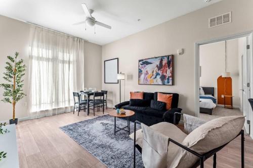 a living room with a couch and a table at Riviere 2BR Apartment Pet Friendly Oasis Sleeps 6 Close to Epic Universe Pool & Gym in Orlando