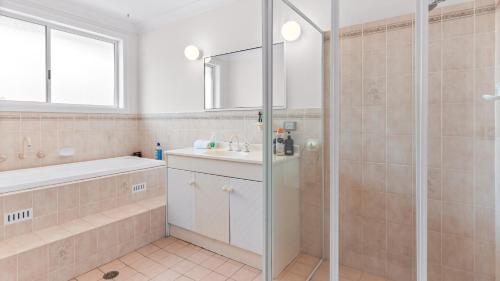a bathroom with a shower and a sink at Evergreen Escape in Forster