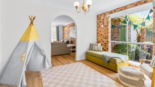 a living room with a bed and a window at Evergreen Escape in Forster