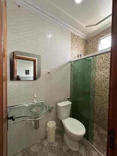 a bathroom with a toilet and a sink and a shower at Hotel Luci in Terra Santa