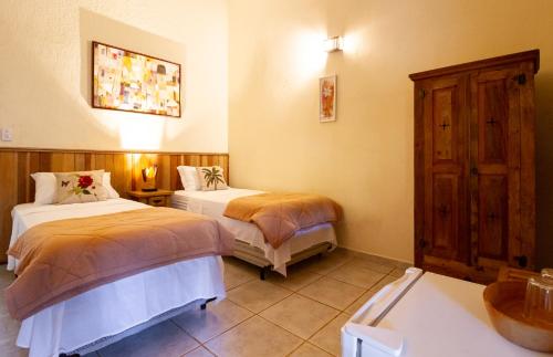 a hotel room with two beds and a sink at Pousada das Cavernas in Iporanga