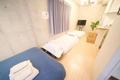 a hospital room with two beds and a table at ラフィット御徒町 in Tokyo