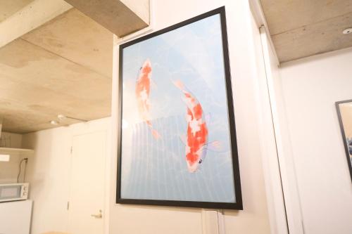 a framed picture of two kites on a wall at ラフィット御徒町 in Tokyo
