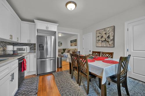 a kitchen and dining room with a table and chairs at Location+Comfort+Convenience in Boston