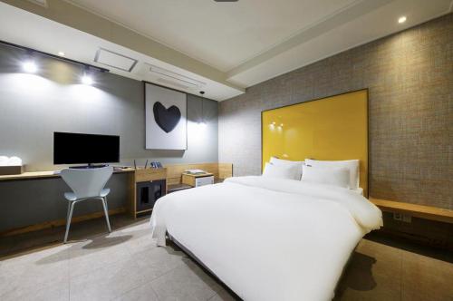 En eller flere senge i et værelse på Cheongju Hotel Persona