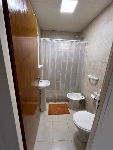 a bathroom with a toilet and a sink at Cabaña zona vivero in Miramar