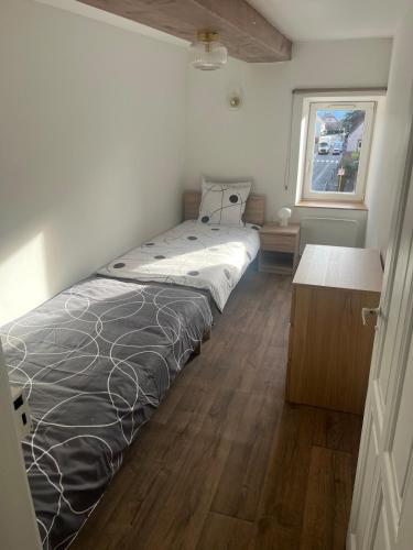 un letto grande in una stanza con una finestra di Spacieux appartement cozy a Saales