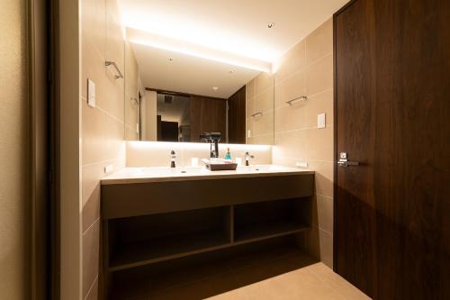 a bathroom with a sink and a mirror at Hotel Clio Court Hakata in Fukuoka