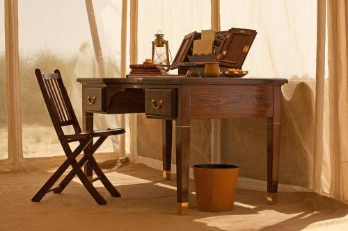 a desk with a mirror and a chair in a room at SUJÁN The Serai Jaisalmer in Jaisalmer