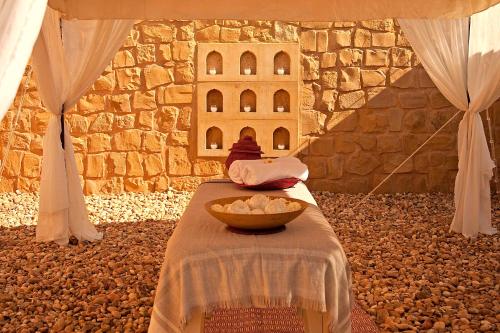 a room with a table with a bowl of food at SUJÁN The Serai Jaisalmer in Jaisalmer