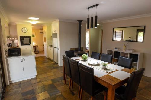a dining room and kitchen with a table and chairs at Camillo Modern Family Retreat - with Private Pool