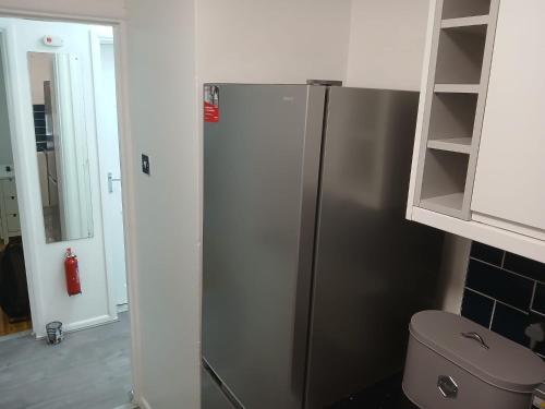 a kitchen with a stainless steel refrigerator in a kitchen at Preferred Comfort Home Thornton Heath London in Thornton Heath