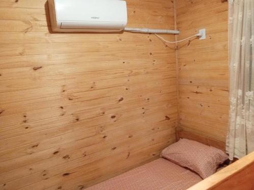 a small room with a wooden wall with a light at Los Sosa y Más in Santa Vitória do Palmar