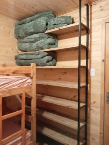 a bunk bed in a cabin with a ladder at Los Sosa y Más in Santa Vitória do Palmar