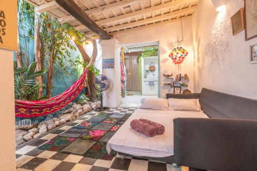 a bedroom with a bed and a tiled floor at Casa Azul Tropical House by Xarm Apartments in Santa Marta