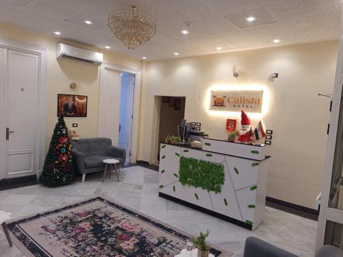 een woonkamer met een kerstboom in een kamer bij Calista Hotel in Caïro