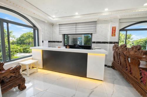 a kitchen with a counter with chairs and windows at 168 Hotel in Ho Chi Minh City