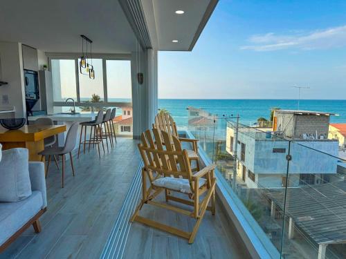 a living room with a view of the ocean at Brand New!! Cozy Beachfront Apartment in Punta Blanca