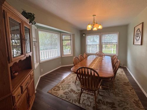a dining room with a wooden table and chairs at Fox Hollow Inn in Bozeman