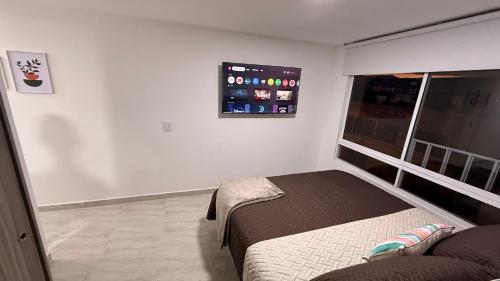 Giường trong phòng chung tại CASA CIELO Quindio