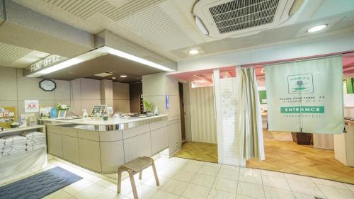 a bathroom with a sink and a counter in a room at Hotel Welcome Matsumoto in Matsumoto