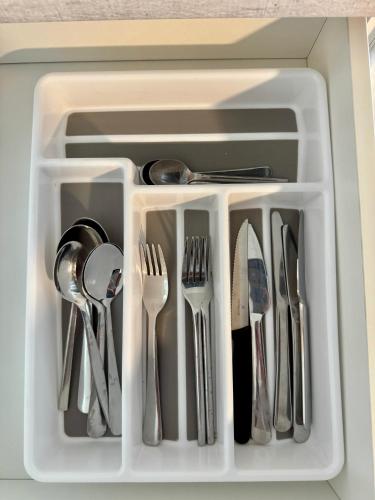 a white tray with utensils in a drawer at Wanaka Matai Studio in Wanaka