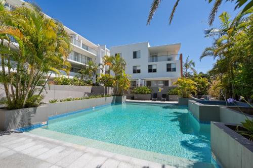 a swimming pool in front of a building at Waterline 202 in Forster