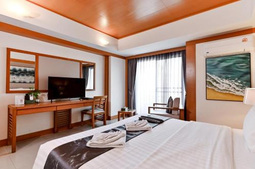 a bedroom with a bed and a desk and a television at Green Residence Ayutthaya - SHA Certified in Phra Nakhon Si Ayutthaya