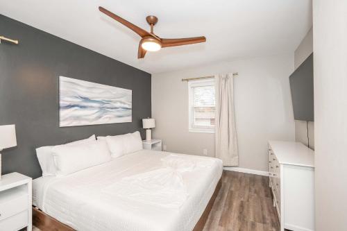 a bedroom with a bed and a ceiling fan at The Terrace Timber House For 8 in Hamilton