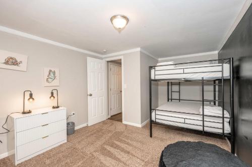 a bedroom with two bunk beds and a desk at The Terrace Timber House For 8 in Hamilton