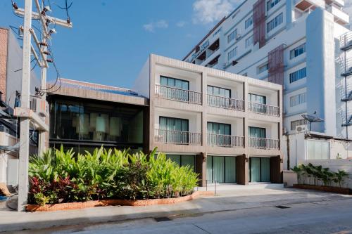 an apartment building with plants in front of it at The Tribe Nimman Boutique Hotel in Chiang Mai